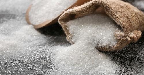 Sack with pure sugar on table