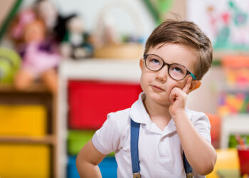Little boy planning in classroom.