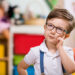 Little boy planning in classroom.