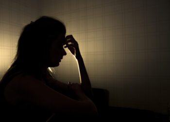 sad woman profile in dark head is put down, stressed young girl touching head and thinkingsad woman profile in dark head is put down, stressed young girl touching head and thinking