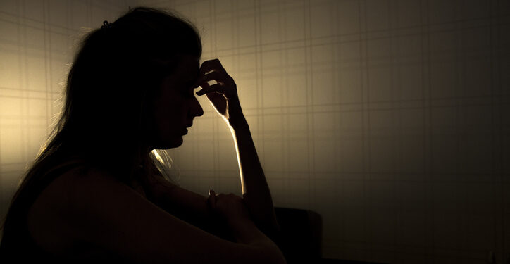 sad woman profile in dark head is put down, stressed young girl touching head and thinkingsad woman profile in dark head is put down, stressed young girl touching head and thinking