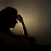 sad woman profile in dark head is put down, stressed young girl touching head and thinkingsad woman profile in dark head is put down, stressed young girl touching head and thinking